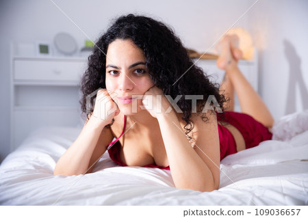 Woman in lingerie enjoying lying on bed 109036657