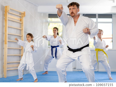 Family repeat position and perform sequence of punches and painful techniques kata 109037155