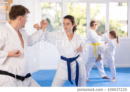 Family with children training karate techniques 109037220