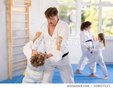 Father and son training judo fighting techniques Father and son training judo fighting techniques 109037221