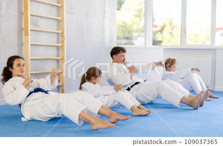 Family with children training abs in gym Family with children training abs in gym 109037365