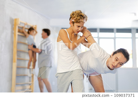 Mother and son training self-defense techniques 109037371