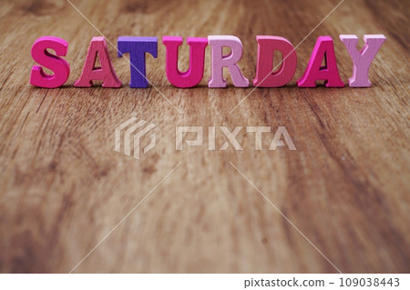 saturday alphabet letters with space on wooden background 109038443