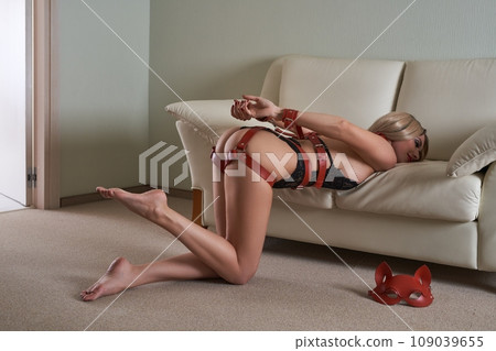 Sexy woman in bondage ready for punishment standing on her knees Sexy woman in bondage ready for punishment standing on her knees 109039655