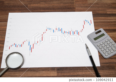 Image of a calculator, loupe, and stock price chart Image of a calculator, loupe, and stock price chart 109042911