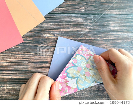 Hands of a woman doing origami 109044173