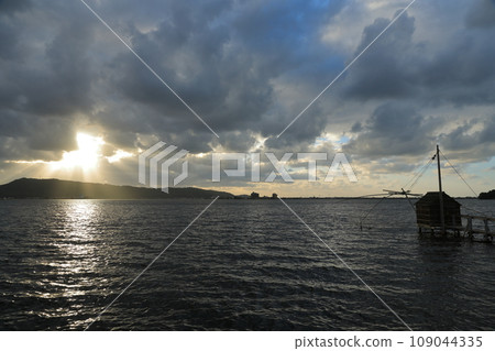 Mysterious sunset view of Togo Pond with sunlight shining through the clouds 109044335