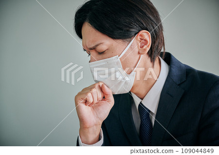 A young male office worker who can't stop coughing A young male office worker who can't stop coughing 109044849