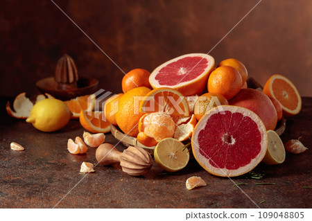Citrus fruits on a old brown table. Citrus fruits on a old brown table. 109048805