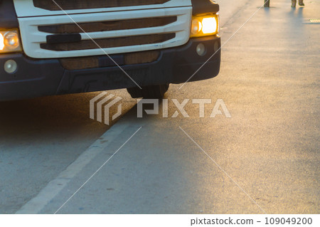 The truck is forced to drive onto the curb of the sidewalk due to the fact that its length is large, and the intersection and the street are narrow, located in the old tourist place of the city The truck is forced to drive onto the curb of the sidewalk due to the fact that its length is large, and the intersection and the street are narrow, located in the old tourist place of the city 109049200