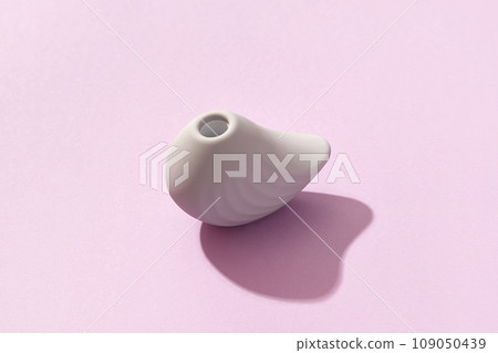 Purple clitoral vibrator on the purple background. Sex toys for adults. Flat lay, top view Purple clitoral vibrator on the purple background. Sex toys for adults. Flat lay, top view 109050439