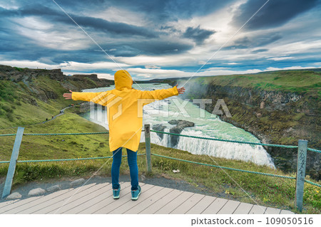 Female tourist enjoying on viewpoint of Gullfoss waterfall with hvita river flowing in canyon at Iceland Female tourist enjoying on viewpoint of Gullfoss waterfall with hvita river flowing in canyon at Iceland 109050516