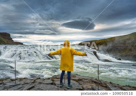 Female tourist enjoying on viewpoint of Gullfoss waterfall with hvita river flowing in canyon at Iceland Female tourist enjoying on viewpoint of Gullfoss waterfall with hvita river flowing in canyon at Iceland 109050518