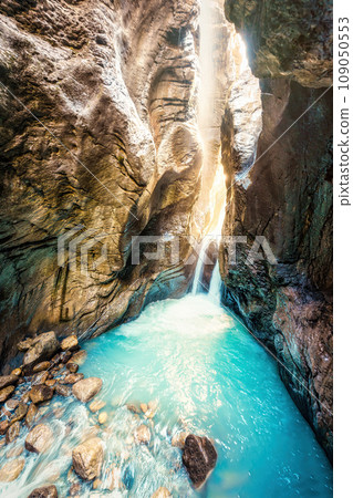 Waterfall with light shines in Rosenlaui glacier gorge at Bernese Alps, Switzerland 109050553