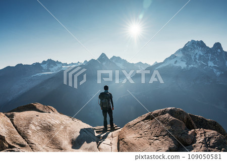 A male hiker standing with enjoying the Mont Blanc mountain range view during trail in Lac Blanc at France 109050581