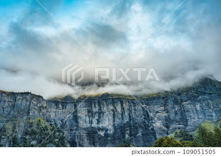 Giffre valley of mountain range with cascade and foggy in the evening at Sixt Fer a Cheval, French Alps, France Giffre valley of mountain range with cascade and foggy in the evening at Sixt Fer a Cheval, French Alps, France 109051505