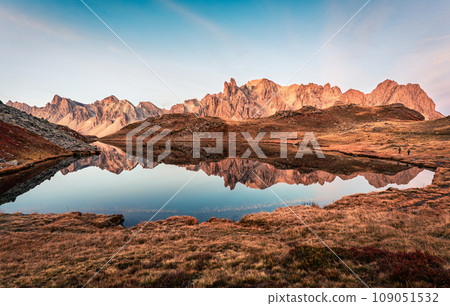 Sunrise over Lac Long with Massif des cerces reflection on the lake in Claree valley at French Alps, France Sunrise over Lac Long with Massif des cerces reflection on the lake in Claree valley at French Alps, France 109051532