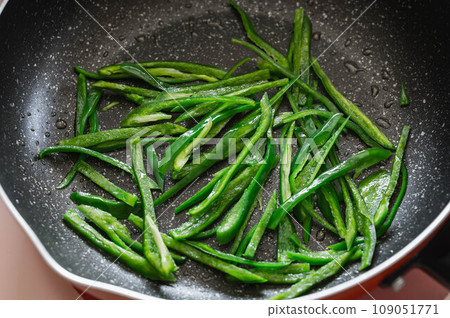 Peppers fried in a frying pan Peppers fried in a frying pan 109051771