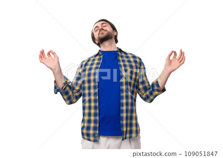 happy brunette brutal man with a beard in a plaid shirt rejoices in good luck happy brunette brutal man with a beard in a plaid shirt rejoices in good luck 109051847