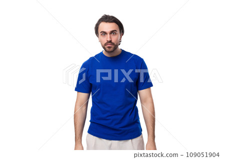portrait of a young stylish caucasian brunette man with a beard in a blue t-shirt 109051904