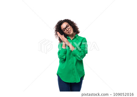 well-groomed young female marketing employee with black hair dressed in a green shirt on a white 109052016