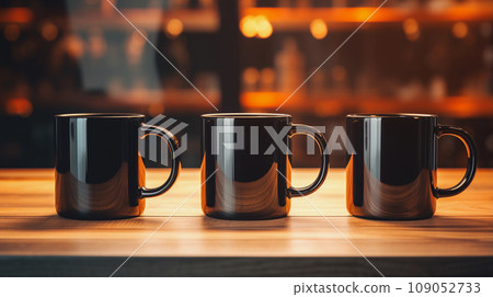 Three Black Mugs Mockup Against the Background of Blurred Lights 109052733