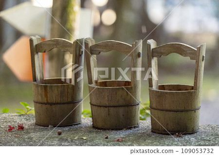Three wooden buckets placed in the precincts of Akayama Zen-in Temple in autumn, Kyoto 109053732