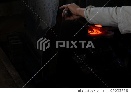Photographing a blacksmith craftsman forging knives, which are essential tools for all traditional crafts. Photographing a blacksmith craftsman forging knives, which are essential tools for all traditional crafts. 109053818