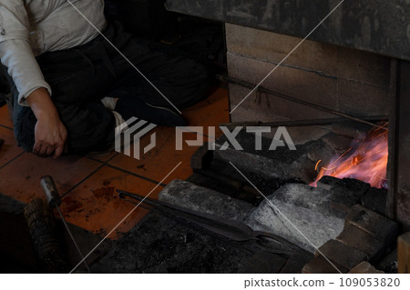 Photographing a blacksmith craftsman forging knives, which are essential tools for all traditional crafts. Photographing a blacksmith craftsman forging knives, which are essential tools for all traditional crafts. 109053820