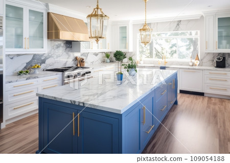 Interior of modern luxurious kitchen classic style. White and blue cabinets with gilded handles, kitchen island with white marble countertop, built-in home appliances, golden pendant lights. Interior of modern luxurious kitchen classic style. White and blue cabinets with gilded handles, kitchen island with white marble countertop, built-in home appliances, golden pendant lights. 109054188