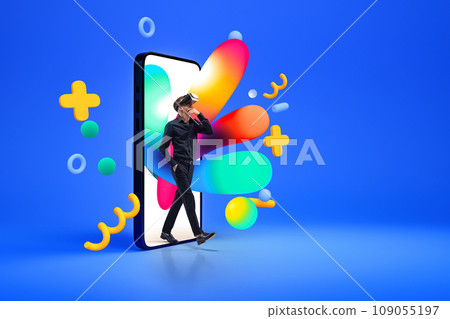 Creative collage with photo of man in virtual reality glasses going out of 3d model of smartphone with colorful splashes and figures isolated blue background. 109055197