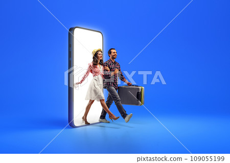 Creative collage with photo of happy young people, lovely couple with baggage, going out from blank phone to book tickets on honey moon against blue background. 109055199