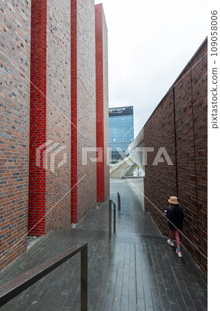 A rear view of girl walking down at modern stairs outdoor. A rear view of girl walking down at modern stairs outdoor. 109058006
