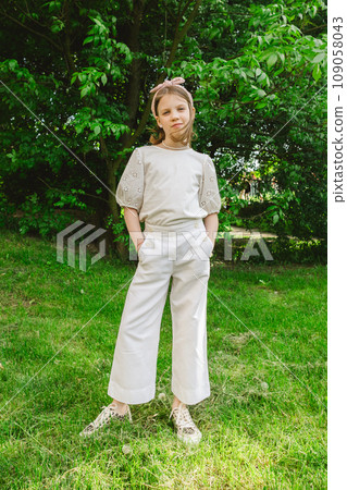 Girl spending time alone at city park in beautiful warm sunny day. 109058043