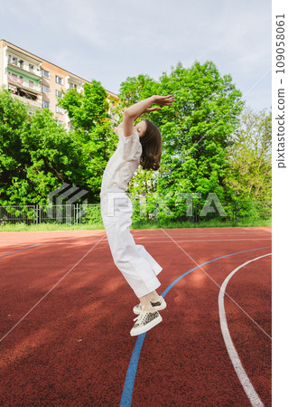 Girl is jumping. Happy funny girl is having fun with outdoor activity in summer. Girl is jumping. Happy funny girl is having fun with outdoor activity in summer. 109058061