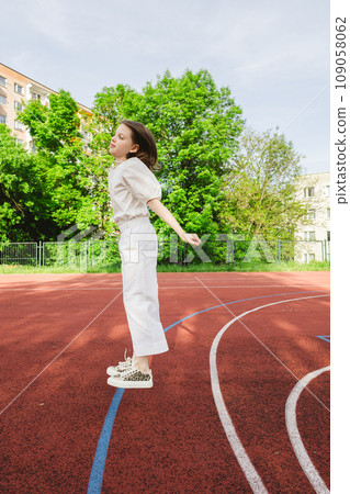 Girl is jumping. Happy funny girl is having fun with outdoor activity in summer. Girl is jumping. Happy funny girl is having fun with outdoor activity in summer. 109058062