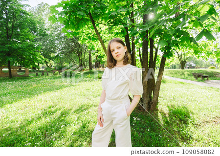 Girl spending time alone at city park in beautiful warm sunny day. Girl spending time alone at city park in beautiful warm sunny day. 109058082