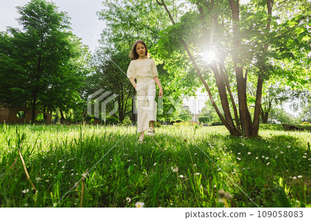 Girl spending time alone at city park in beautiful warm sunny day. Girl spending time alone at city park in beautiful warm sunny day. 109058083