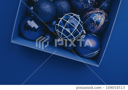 Red Christmas baubles decoration in the box on red background Red Christmas baubles decoration in the box on red background 109058513