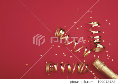 Champagne bottle with confetti stars on color background, space for text Champagne bottle with confetti stars on color background, space for text 109058528