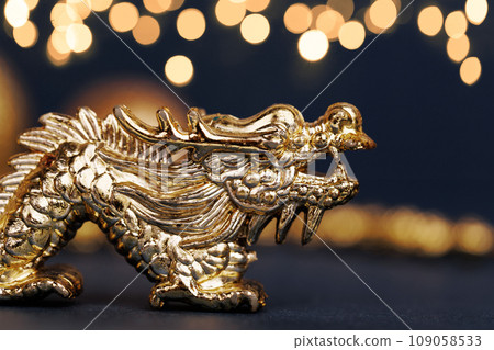 Golden dragon symbol of the year 2024 on a dark background Golden dragon symbol of the year 2024 on a dark background 109058533
