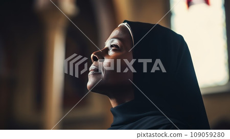 Middle aged African American nun praying 109059280