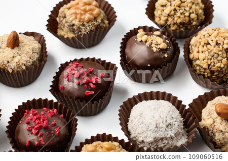 Set of round chocolate candies with nuts on a white background 109060516