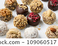 Set of round chocolate candies with nuts on a white background 109060517