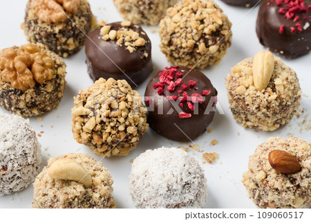 Set of round chocolate candies with nuts on a white background 109060517