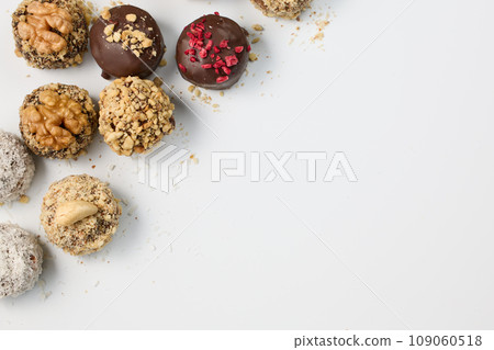 Set of round chocolate candies with nuts on a white background 109060518
