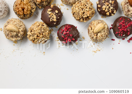 Set of round chocolate candies with nuts on a white background 109060519