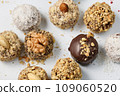 Set of round chocolate candies with nuts on a white background 109060520