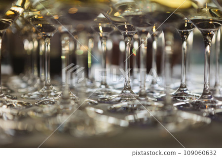 Glasses with white and red wine. Catering services. Glasses with wine in row background at restaurant party. Shallow dof Glasses with white and red wine. Catering services. Glasses with wine in row background at restaurant party. Shallow dof 109060632