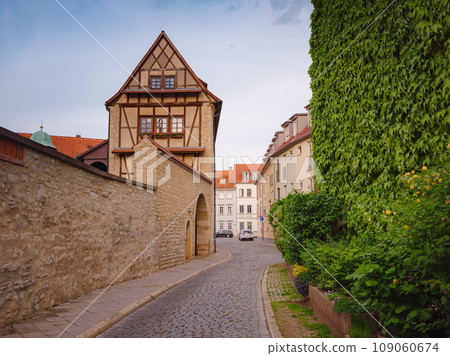 spring trip to Europe. Travel and German sightseeing locations. scenic view to facade of old historic houses somewhere in Erfurt city, Traditional half-timbered houses makes cozy and fairy tail mood spring trip to Europe. Travel and German sightseeing locations. scenic view to facade of old historic houses somewhere in Erfurt city, Traditional half-timbered houses makes cozy and fairy tail mood 109060674